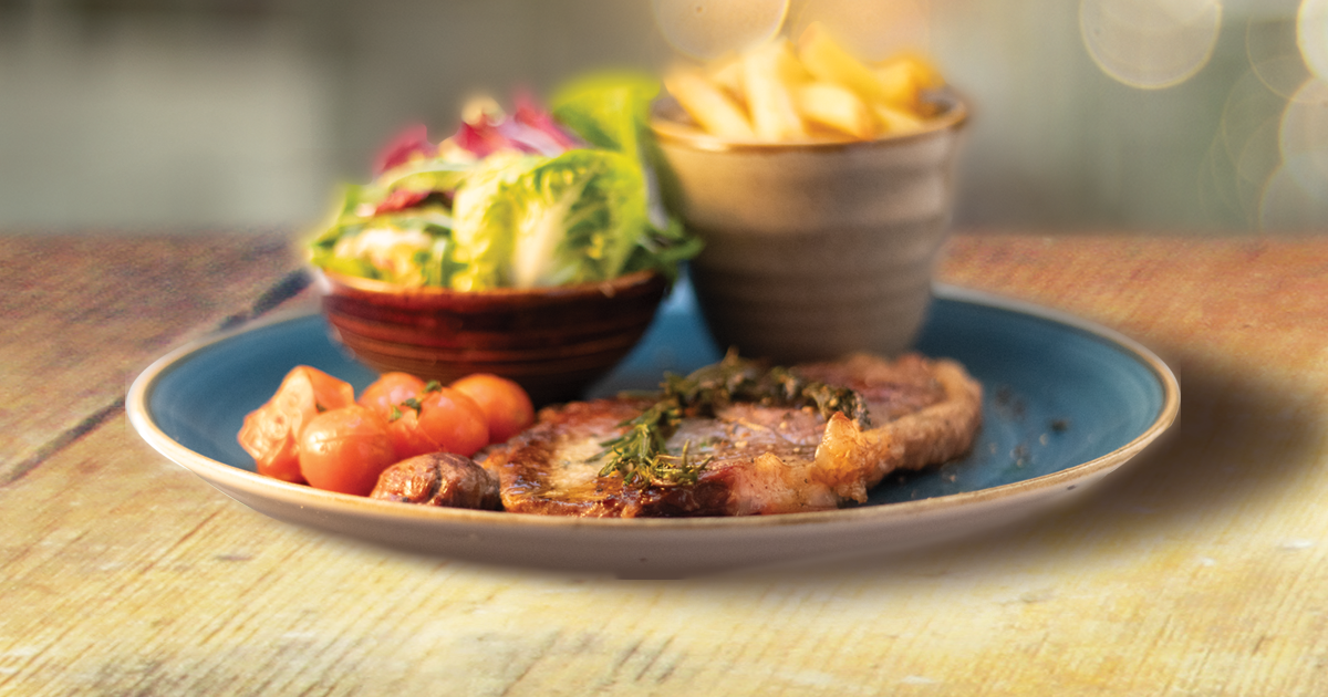 Steak with skin on fries and salad.